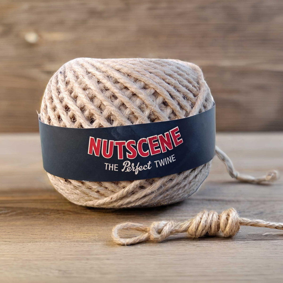 A ball of nutscene twine with black label on a wooden background