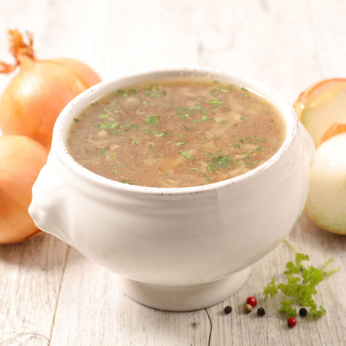 A bowl of soup using Yellow Sweet Spanish onions with other onions in the background.