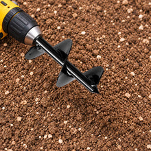 power planter bulb planting auger attached to a drill laying on dirt.