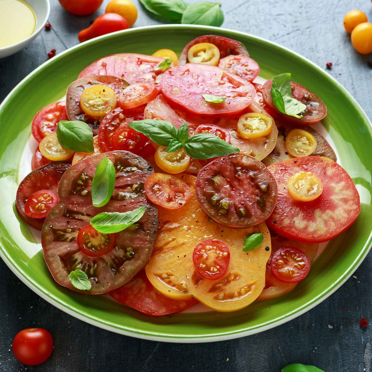 A plate of sliced Heirloom Rainbow tomatoes both large and small.